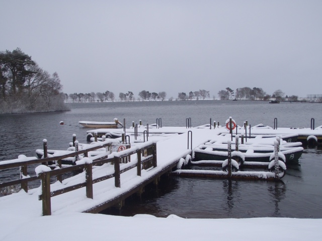 Snow obscures boats at Island Pond.